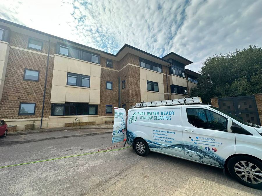 Pure Water Ready van outside a modern apartment development