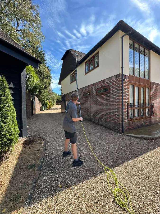 Reaching an upper window on a large country home