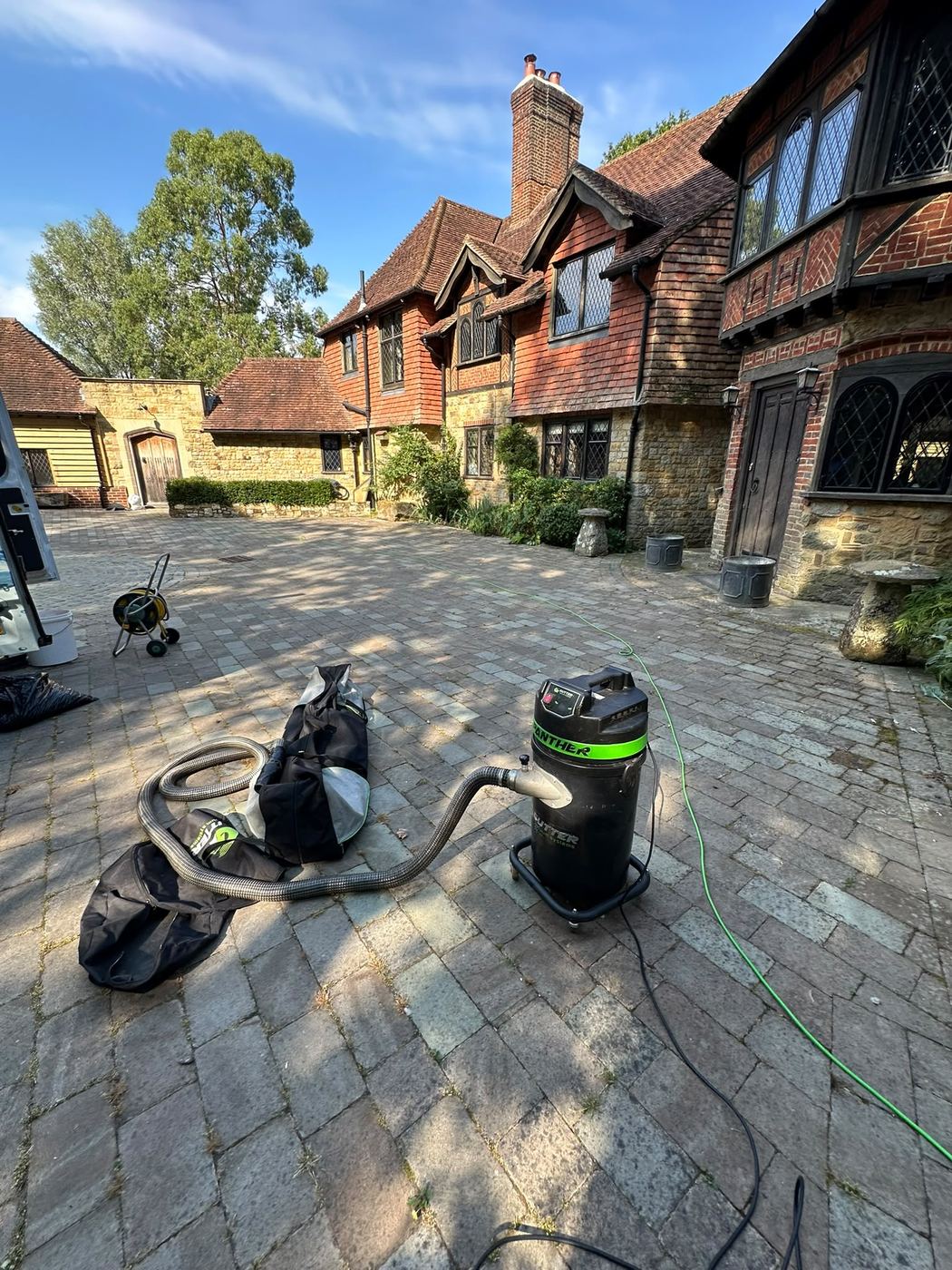 Gutter vacuum equipment clearing a gutter on a large property