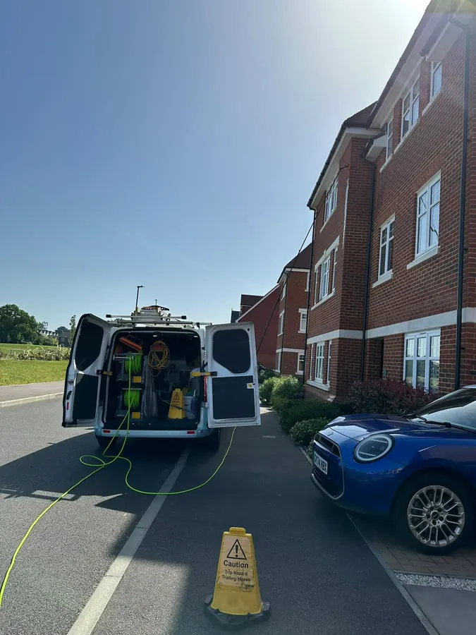 Pure Water Ready van set up outside a three-storey apartment building